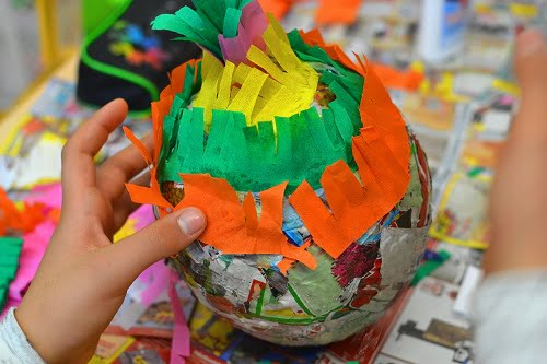 Children hands are making a pinata.